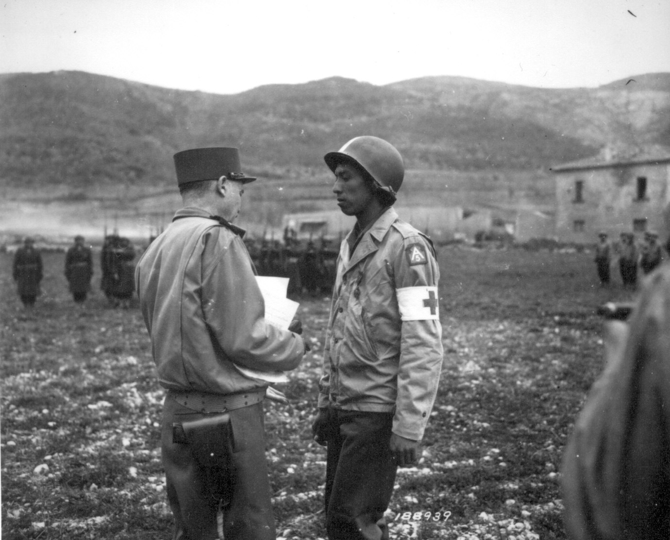 US Army Private Jonathan Hoag, a medic, was awarded a Croix de Guerre by French General Alphonse Juin for courage shown in treating the wounded, Pozzuoli, Italy, 21 Mar 1944