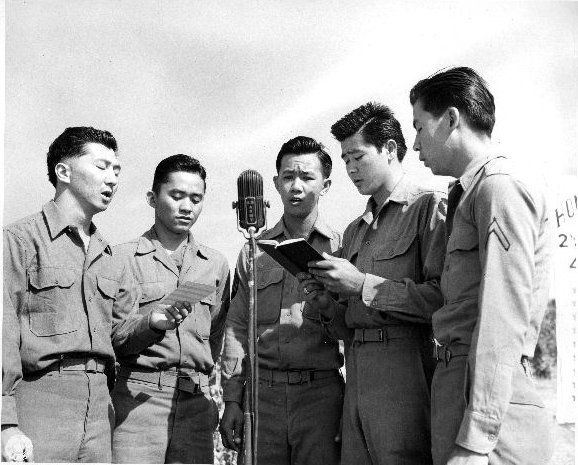 Japanese-American soldiers of US 442nd Regimental Combat Team singing 'Abide in Me' at the memorial ceremony for fallen soldiers, Cecina Area, Italy, 30 Jul 1944