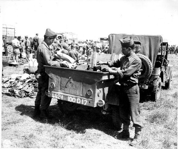 Japanese-American troops of 100th Infantry Battalion, US 442nd Regimental Combat Team inspecting a confiscated German field kitchen, Brescia, Italy, 18 May 1945, photo 2 of 2
