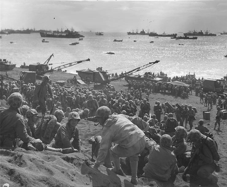 Troops moving ashore at a Iwo Jima beach, circa 20-21 Feb 1945