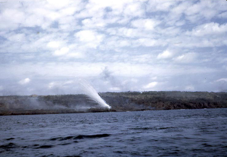 Explosion of a white phospherus shell or bomb near shore on Iwo Jima, circa Feb 1945