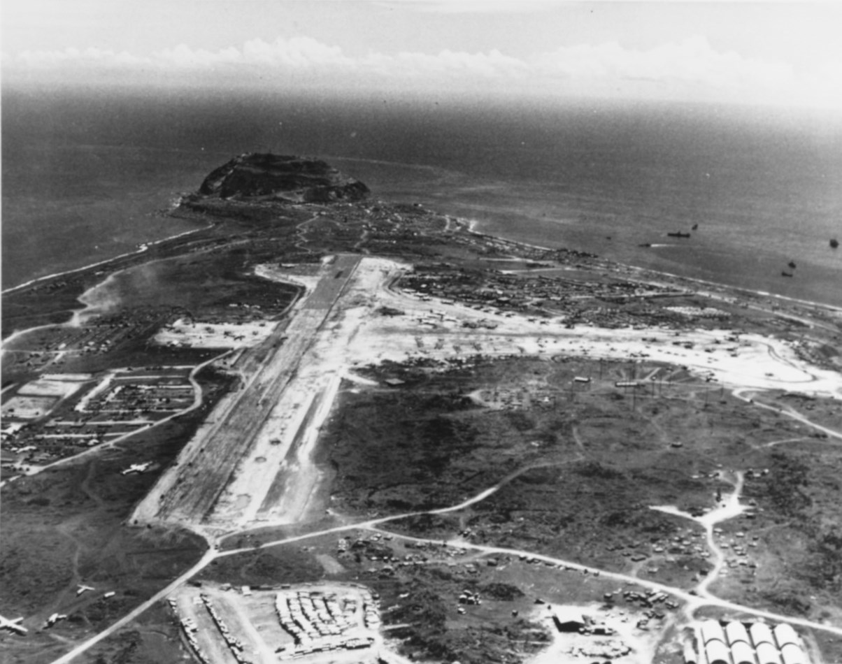 Aerial view looking southward over Iwo Jima's South Airfield (formerly Japanese Airfield # 1), with Mount Suribachi in the distance, 26 May 1945; note B-29 bombers on the field
