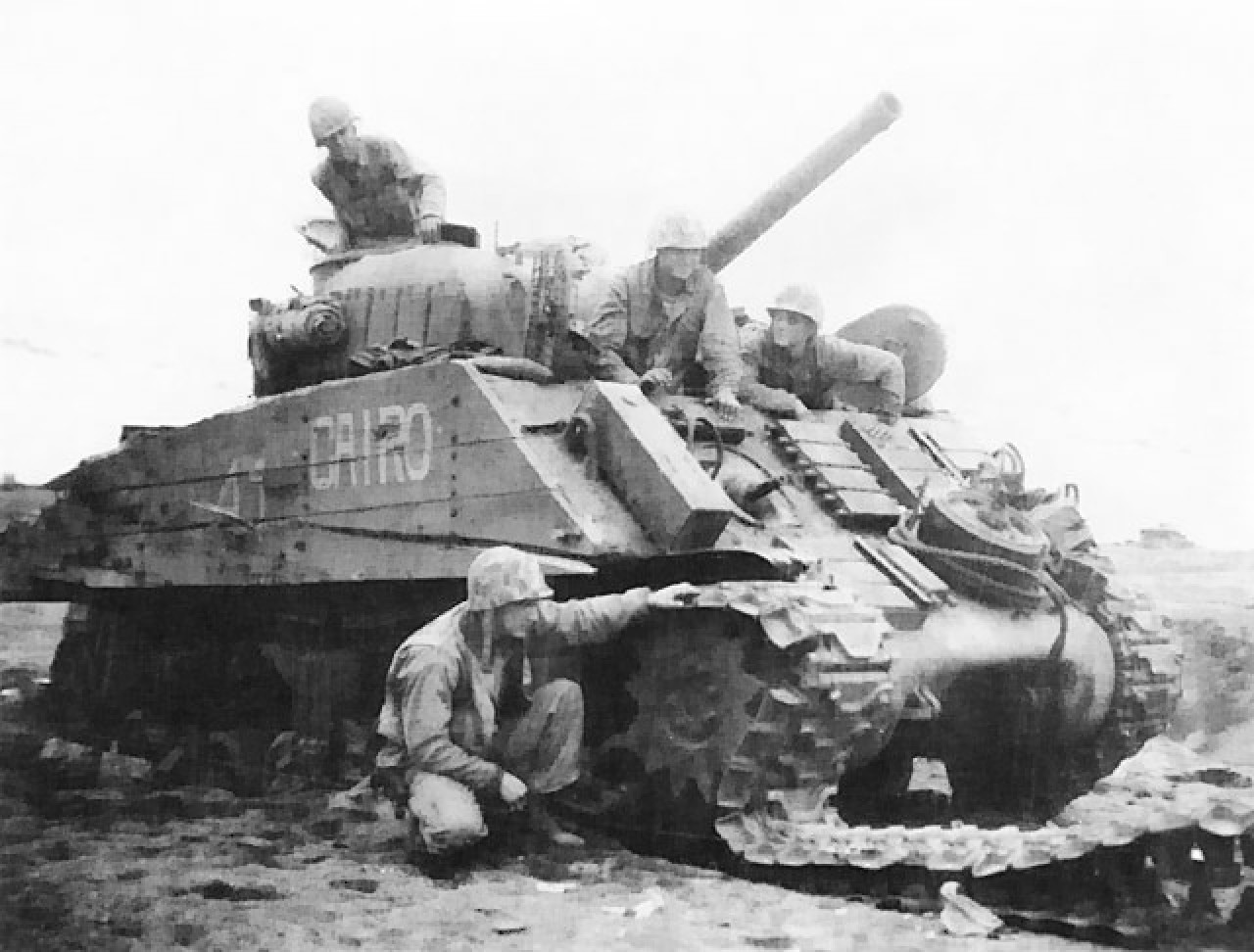 M4 Sherman 'Cairo' disabled by land mine, Iwo Jima, Japan, Feb 1945; note heavy wooden side planking meant to protect against magnetic demolition charges.