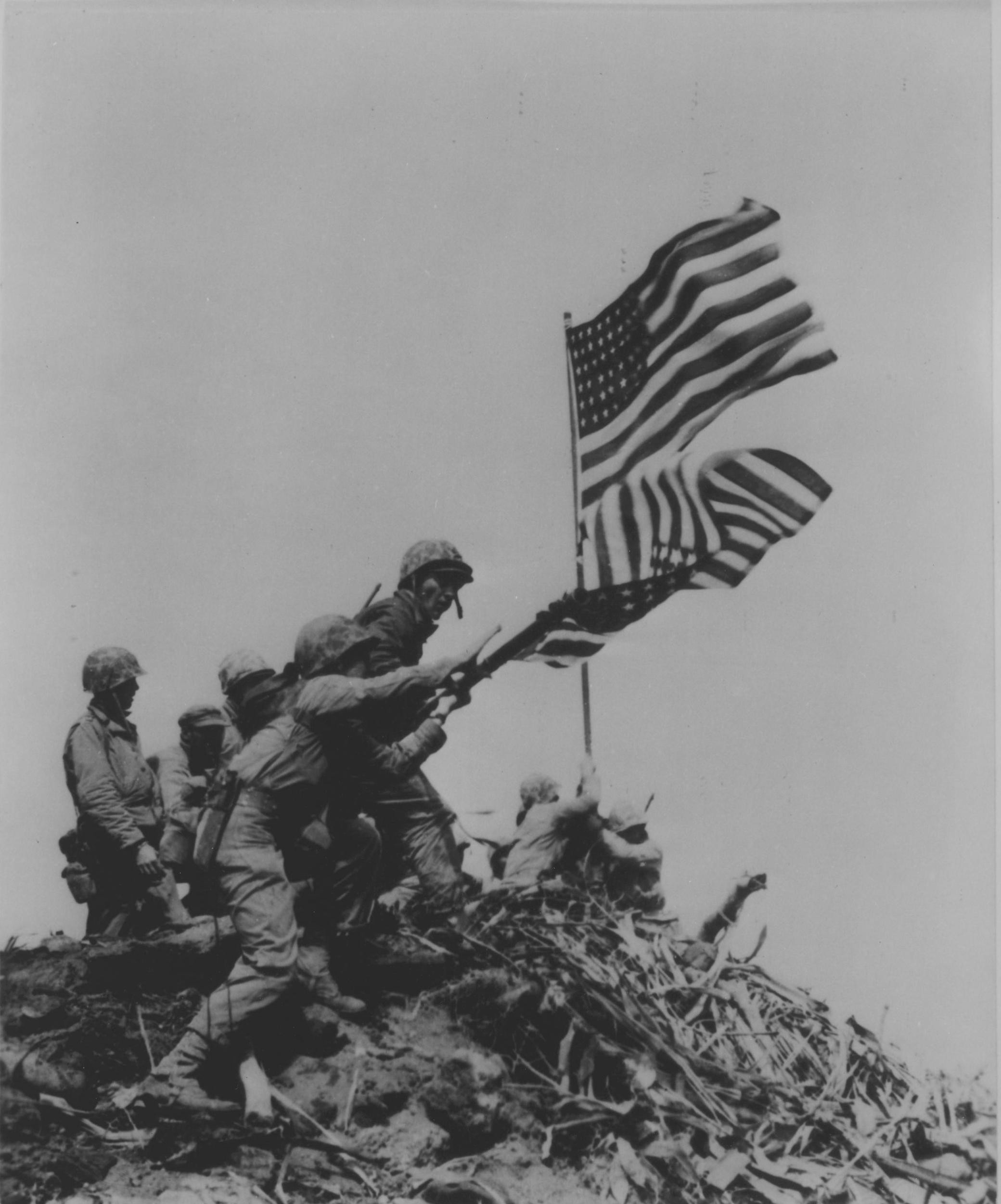 US Marines removing the first Mount Suribachi flag as the second flag was being raised, Iwo Jima, Japan, 23 Feb 1945