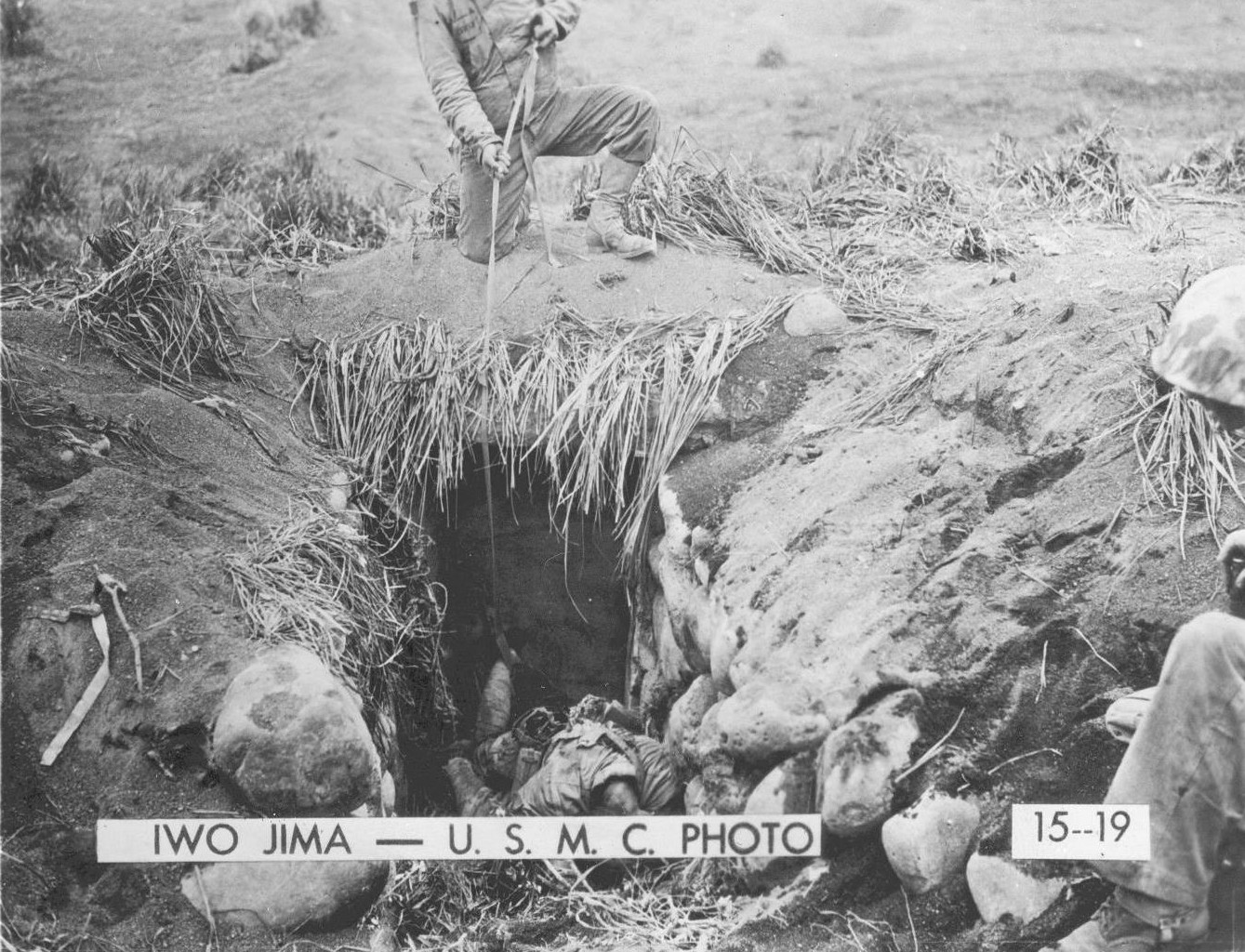 US Marines observing dead Japanese soldiers in a cave on Iwo Jima, Feb 1945