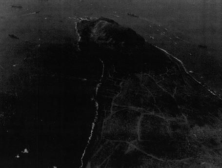 View of the northern face of Mount Suribachi, Iwo Jima, Japan, 7 Mar 1945; photo taken from an aircraft of USS Anzio