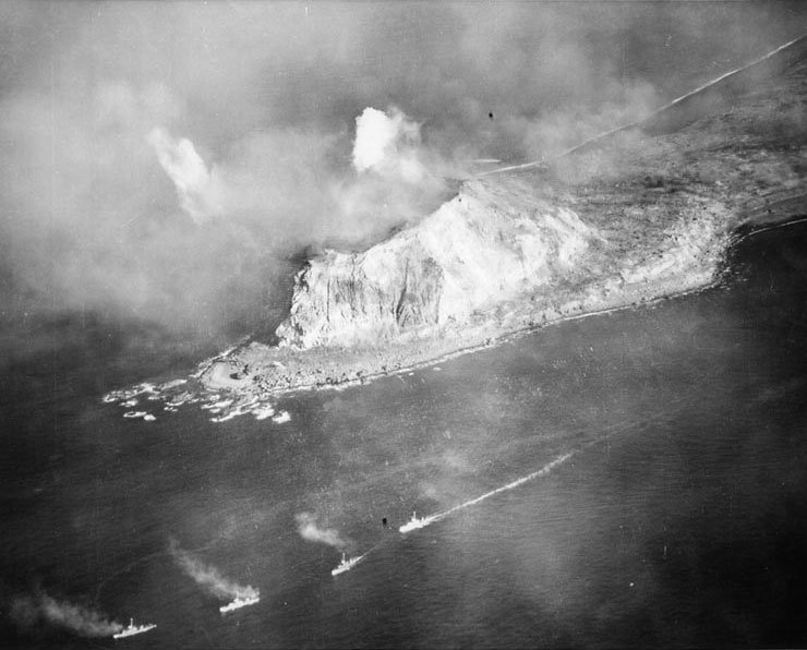 A column of landing craft support vessels passing by Mount Suribachi, Iwo Jima, Japan, 18 Feb 1945
