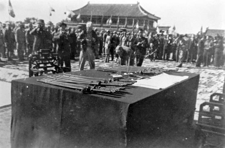 Surrendered Japanese officers' swords and the signed Japanese surrender document, Forbidden City, Beiping, China, 10 Oct 1945