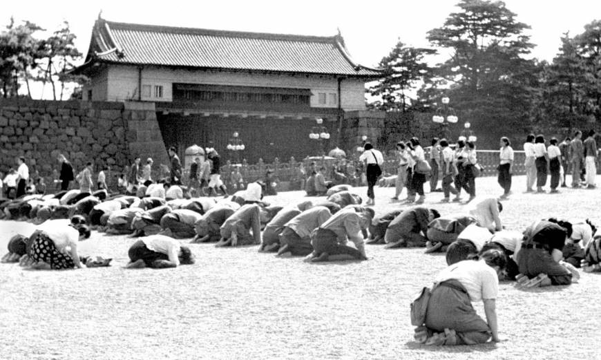 Japanese civilians listening to Emperor Showa's surrender address outside the Imperial Palace, Tokyo, Japan, 15 Aug 1945