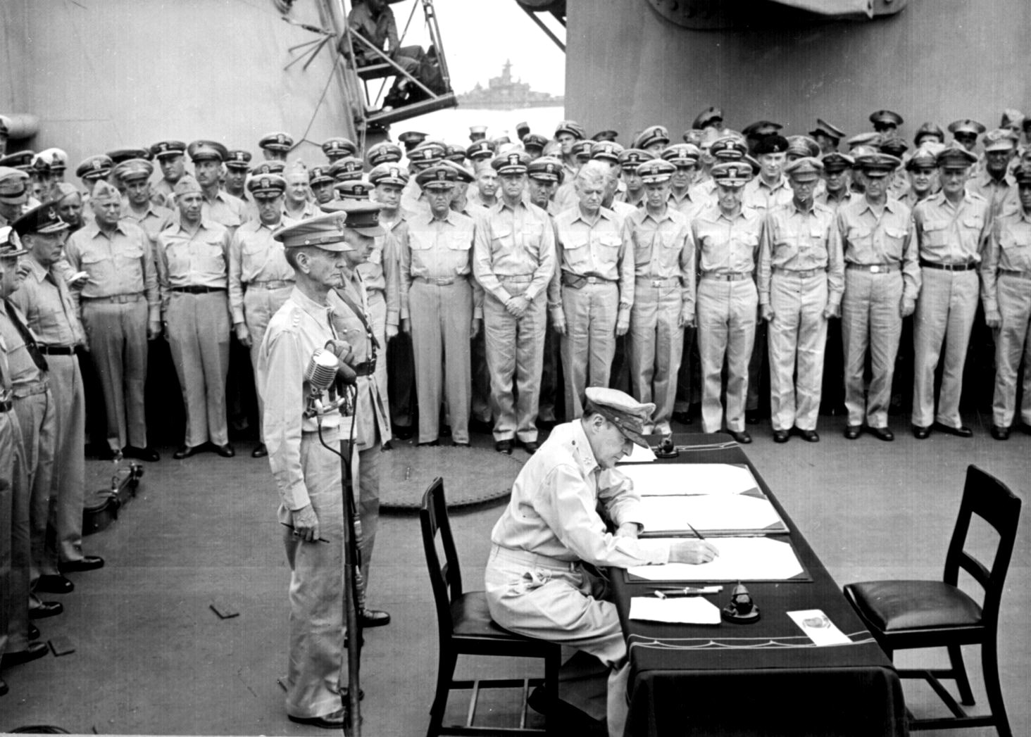 MacArthur signing Japanese surrender aboard USS Missouri, 2 Sep 1945, photo 4 of 4