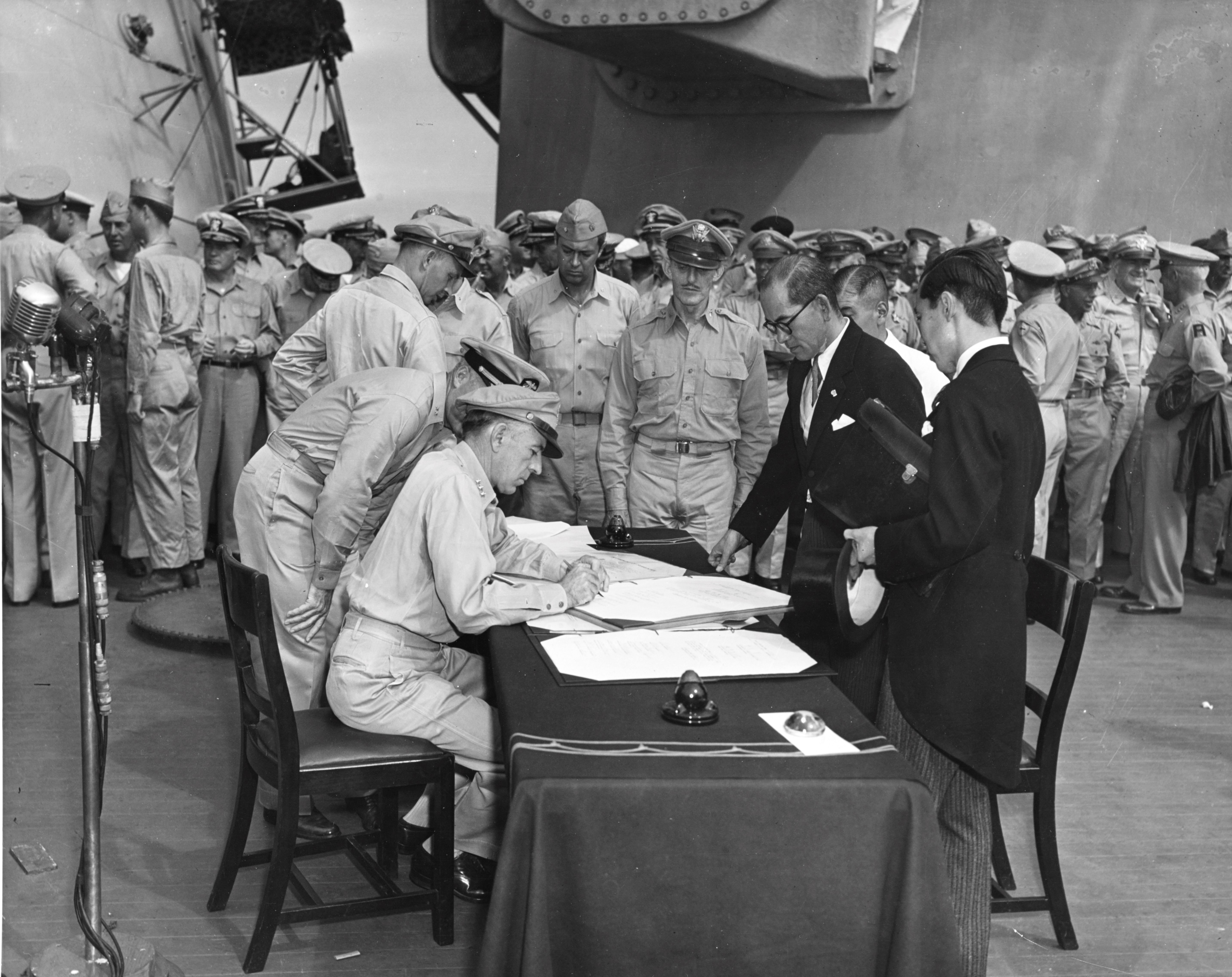 Lieutenant General Sutherland correcting Japanese surrender document, 2 Sep 1945, photo 1 of 2