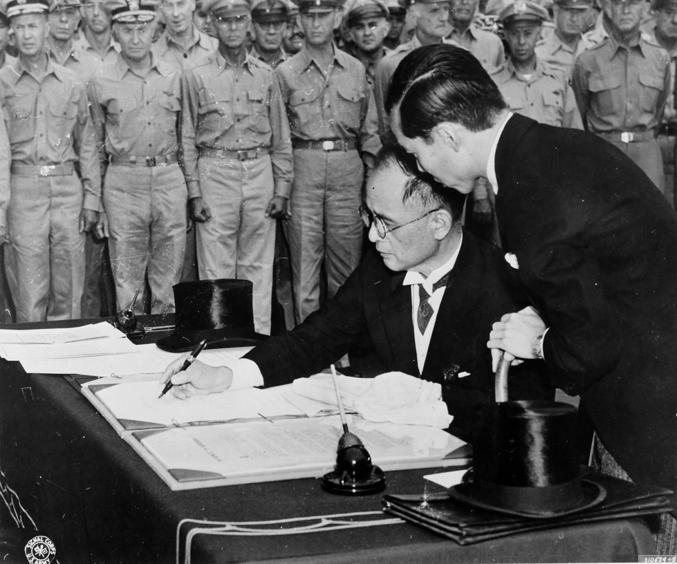 Mamoru Shigemitsu signing the surrender instrument aboard USS Missouri, Tokyo Bay, Japan, 2 Sep 1945, photo 3 of 4