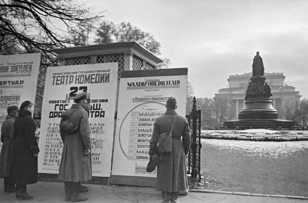 Civilians and soldiers reading theater marquees in Leningrad, Russia, Oct 1941