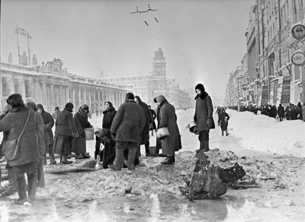 Citizens of Leningrad, Russia fetching water from a shell hole in Ostrovsky Square, 1 Dec 1941