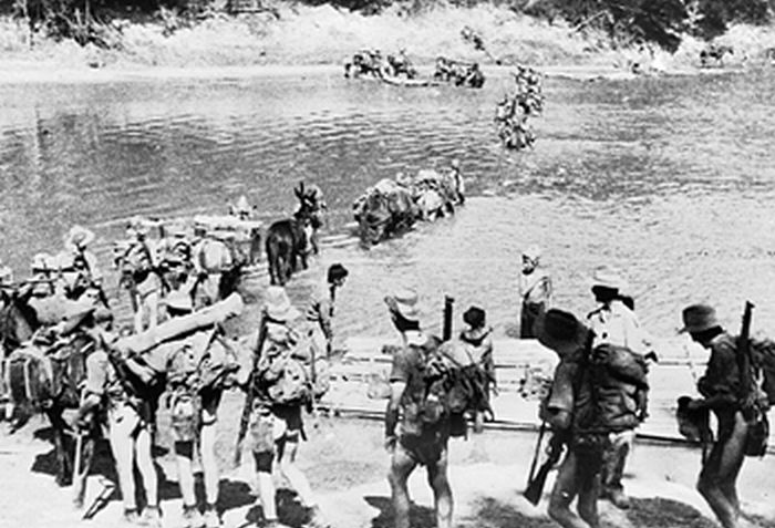 A column of Chindit irregular troops crossing a river in Burma, Feb-Mar 1943
