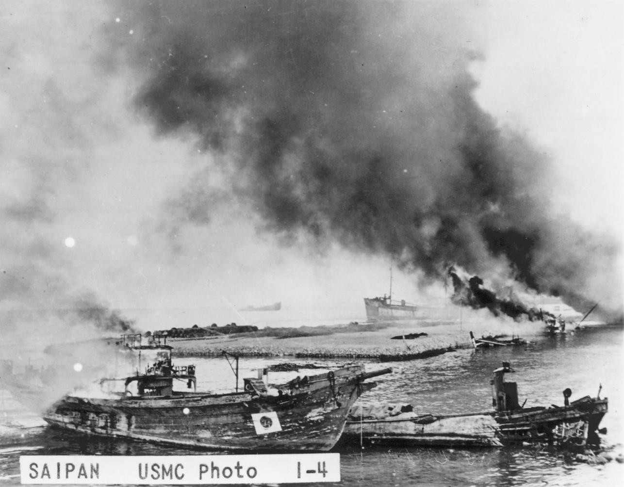 Japanese vessels burning at a harbor near Garapan, Saipan, Mariana Islands, Jun 1944