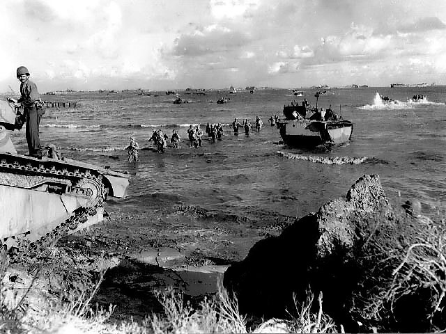 US Marines wading toward Tinian from amphibious tractors and landing boats, Mariana Islands, 25 Jul 1944, photo 1 of 3