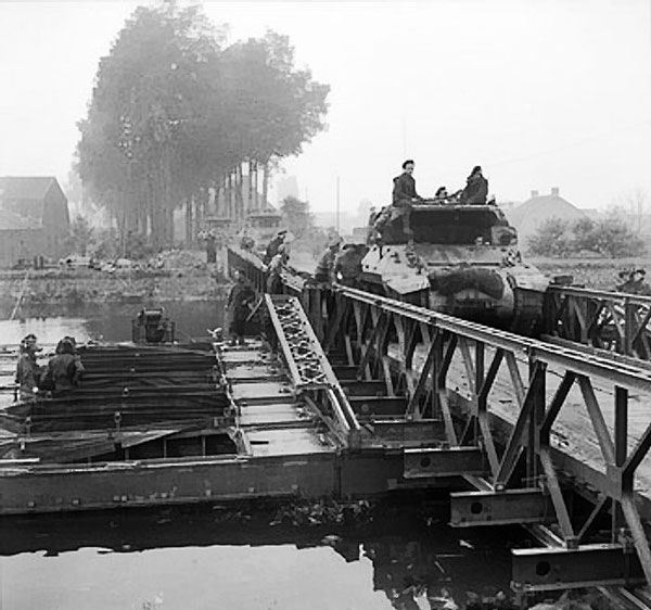 M10 Wolverine tank destroyers of 75th Anti-Tank Regiment Royal Artillery of British 11th Armoured Division crossing a Bailey bridge over the Meuse-Escaut (Maas-Schelde) Canal at Lille St Hubert, Belgium, 20 Sep 1944