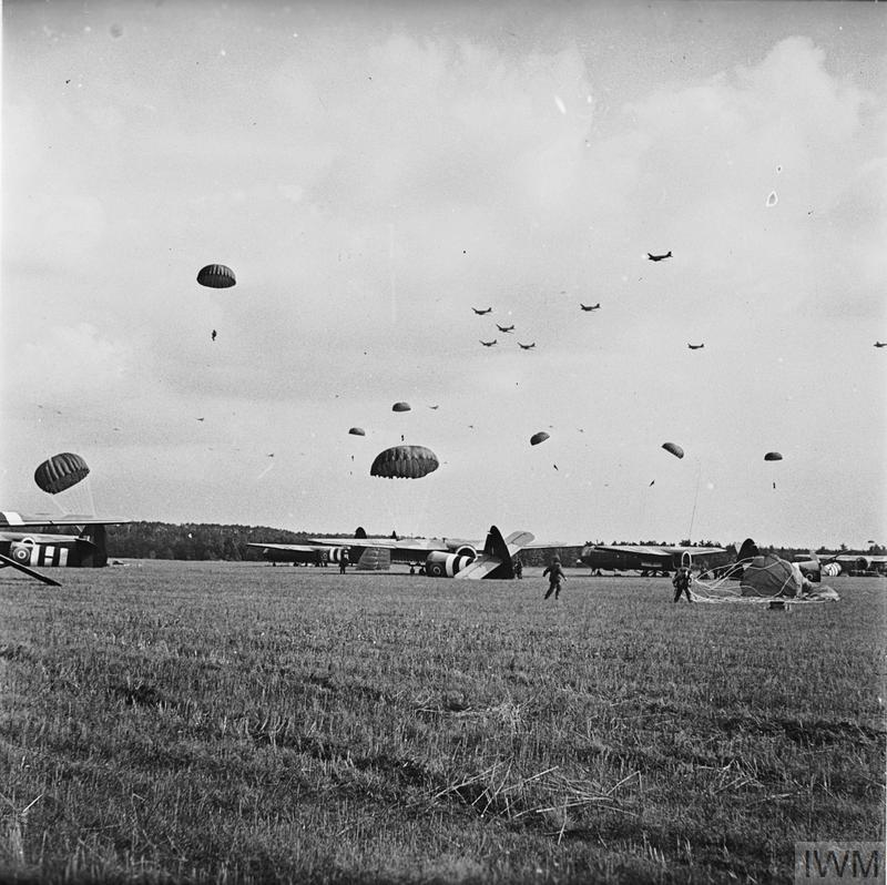 British paratroopers of 1st Airlanding Reconnaissance Squadron on the ground gathering their parachutes, Arnhem, Gelderland, the Netherlands, 17 Sep 1944