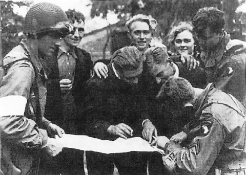 Troops of US 101st Airborne Division receiving information from Dutch resistance members, Eindhoven, the Netherlands, Sep 1944