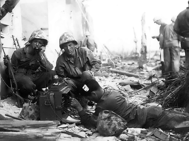 US Marine signalmen setting up a command post in the streets of Roi-Namur, Kwajalein, Marshall Islands, 1 Feb 1944