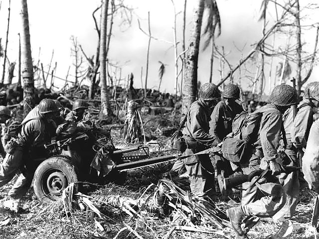 Soldiers of the US Army 7th Division moving a 37 mm Gun M3 anti-tank gun on Kwajalein, Marshall Islands, Feb 1944