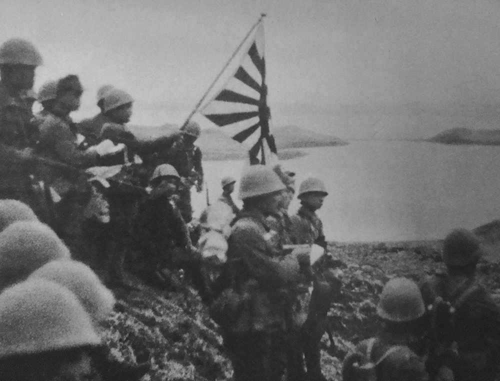 Troops of the Japanese Special Naval Landing Force raising the Japanese naval ensign on Kiska Island, Aleutian Islands, 6 Jun 1942