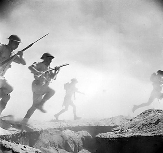Australian soldiers running toward the front lines during re-enactment of the Battle of El Alamein, 24 Oct 1942