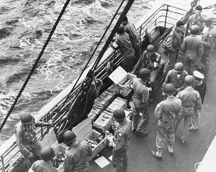 US Army troops of the 3rd Infantry Division drew ammunition on board USS Joseph T. Dickman (AP-26), off Morocco, 7 Nov 1942