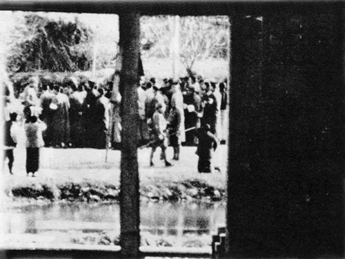 Chinese women begging Japanese troops to spare the lives of their husbands and sons who were being rounded up on Shanghai Road, Nanjing, China, 16 Dec 1937