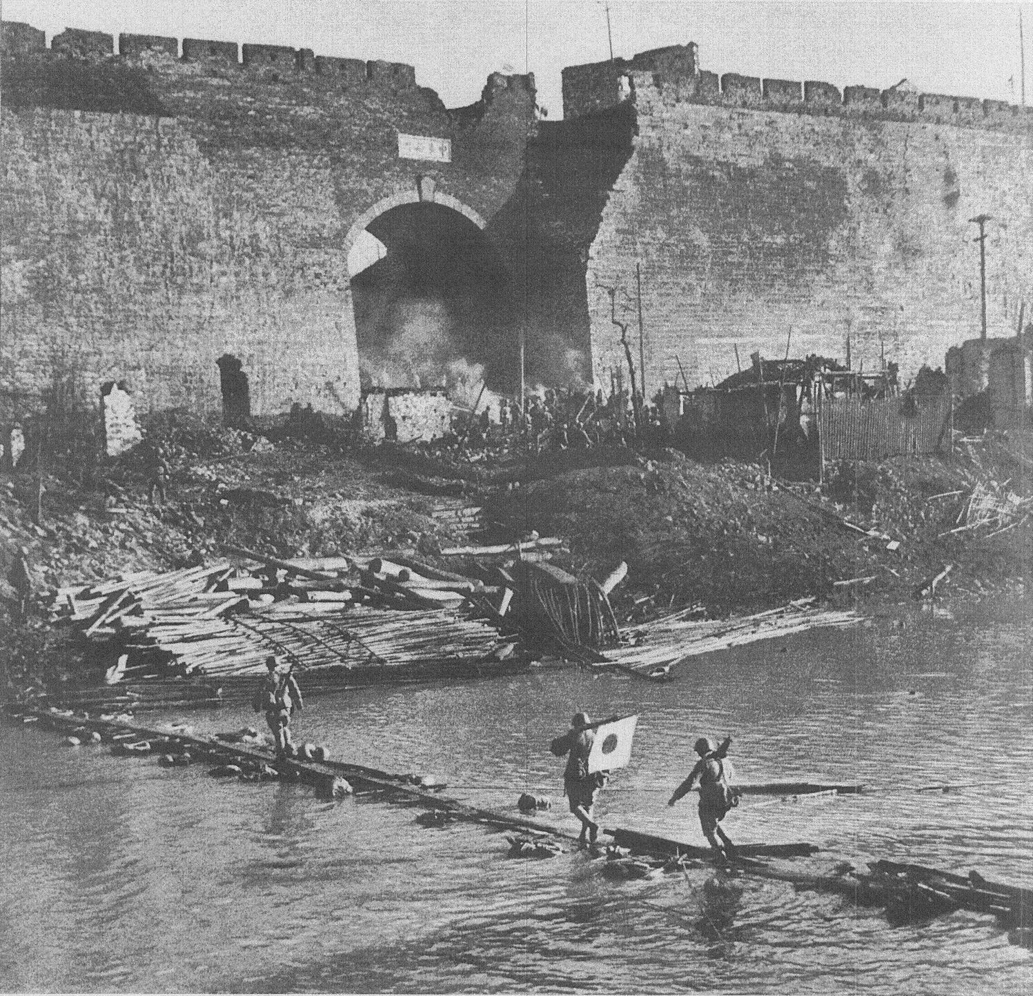 Japanese soldiers crossing a river near the Nanjing city wall, China, 13 Dec 1937