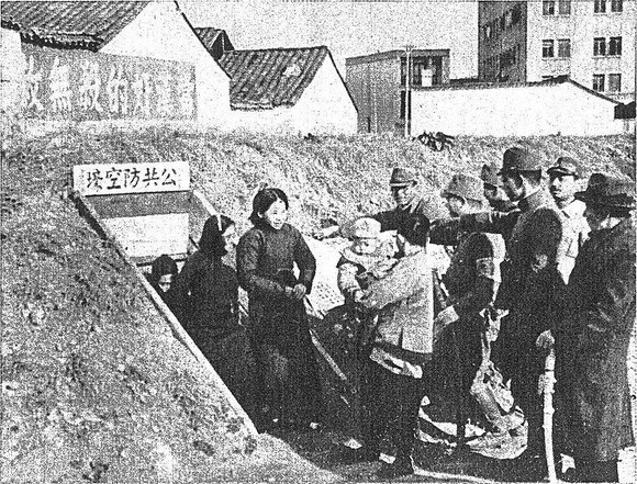 Japanese troops ordering Chinese civilians out of an air raid shelter, Nanjing, China, 14 Dec 1937