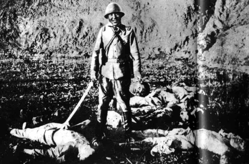 Japanese soldier holding the severed head of a Chinese civilian, Nanjing, China, Dec 1937-Jan 1938