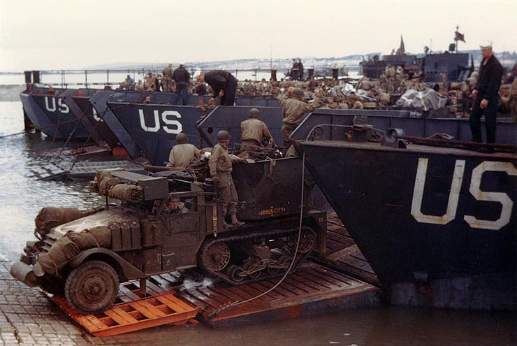 A US Army half-track antiaircraft machine gun vehicle backed into the well deck of a US Navy LCT in preparation for the Normandy invasion, late May or early Jun 1944. Photo 1 of 2