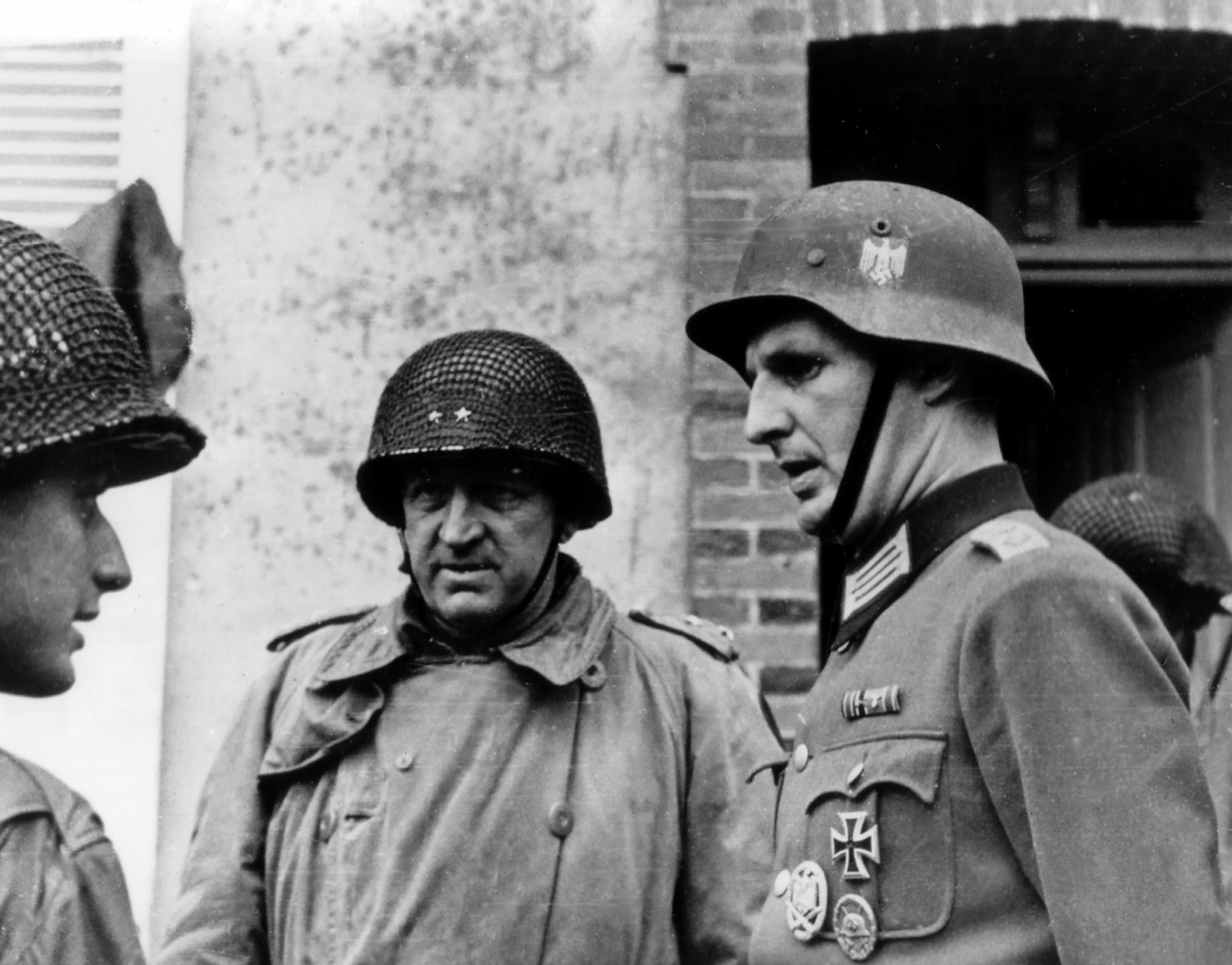 Major General Manton Eddy and another American officer speaking to a captured German officer, Cherbourg, France, 26-27 Jun 1944