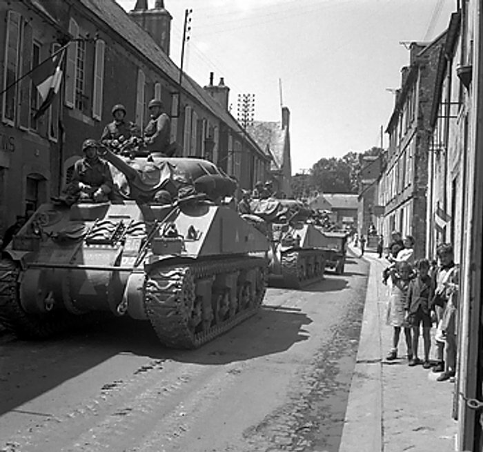 Sherman tanks of UK 30th Corps passing through Bayeaux, France, 17 Jun 1944
