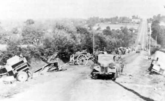 Abandoned German equipment on a road to Avranches, France during Operation Cobra, 31 Jul 1944