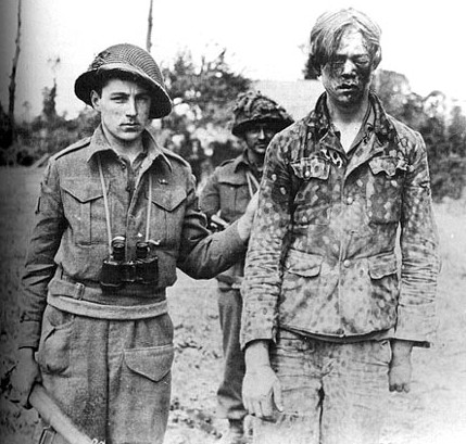 A Hitler Youth soldier captured by Canadian soldiers, Caen, France, 9 Aug 1944