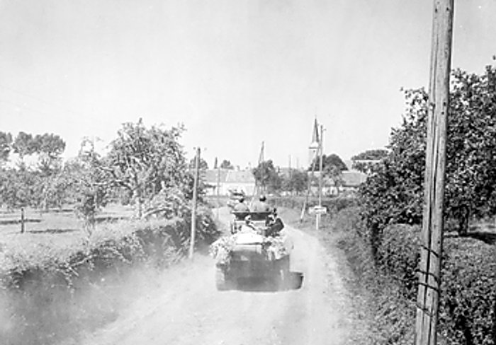 American soldiers and vehicle in Ballon, France, circa 18-20 Aug 1944