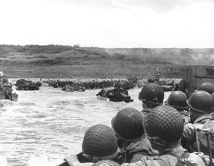 American troops watched activity ashore on Omaha Beach as their LCVP landing craft approached the shore, Normandy, 6 Jun 1944, photo 2 of 2