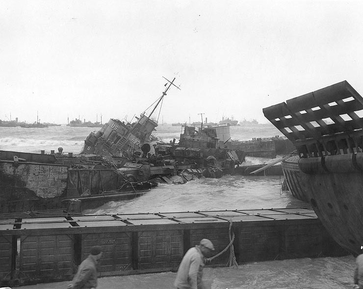LCT-25 and LCI(L)-497 lay wrecked off Omaha Beach, Normandy, amidst a storm, 21 Jun 1944