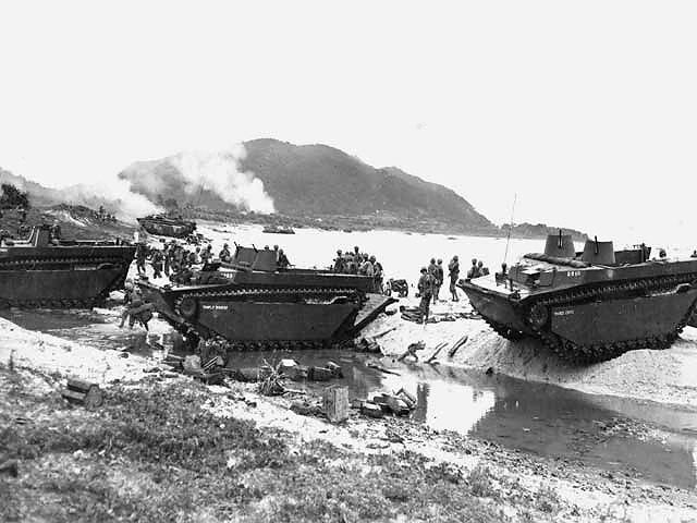 Amphibious tractors delivering US Marines and supplies on the beach of Ibeya, an island in the Ryukyu Islands northwest of Okinawa, 3 Jun 1945