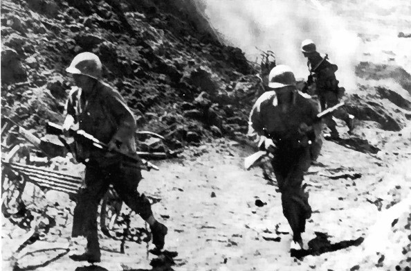 US corkscrew demolition team at Okinawa, Japan, circa Apr-Jun 1945; note cave blast in background