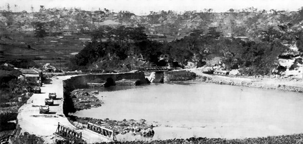 Machinato Inlet immediately after combat, Okinawa, Japan, 19 Apr 1945; note wrecked M29 Weasel vehicles on the road