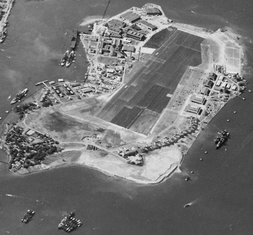 Aerial view looking south at Ford Island, Pearl Harbor, US Territory of Hawaii, 30 Oct 1941; note partial view of Battleship Row at left and USS Enterprise at upper left