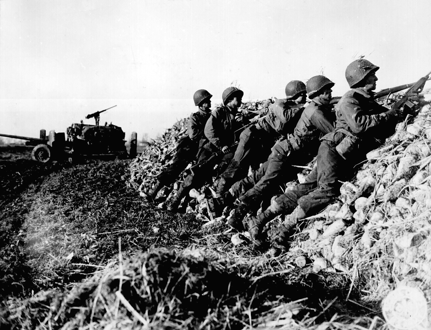 US Army anti-tank infantry searching for the position of a German machine gun that had fired on their vehicle, the Netherlands, 4 Nov 1944