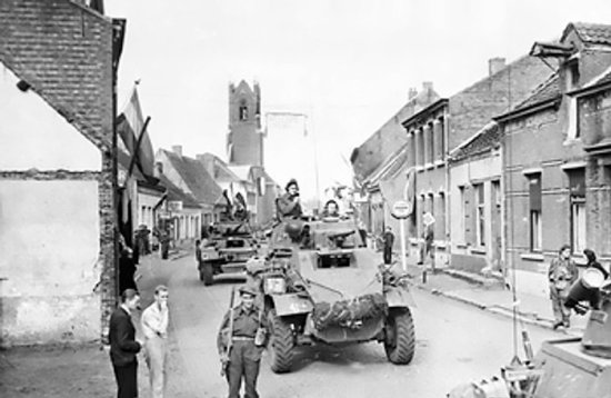 Canadian Daimler and Humber armored cars in the Belgian-Dutch border town of Putte, 11 Oct 1944; note Sint-Dionysiuskerk in background, and the photo was likely taken on the border looking north into the Netherlands