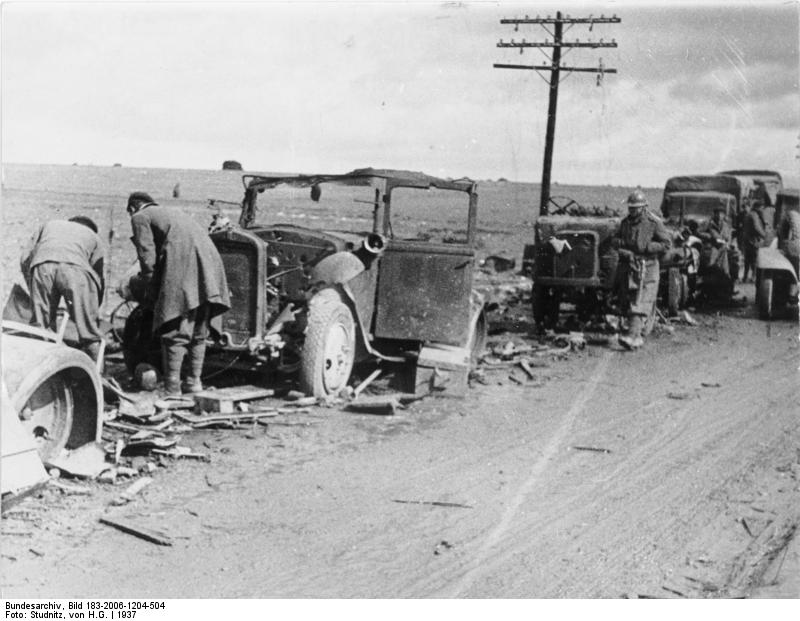 A column of vehicles destroyed by aircraft pushed to the side of a road, Battle of Guadalajara, Spain, Mar 1937