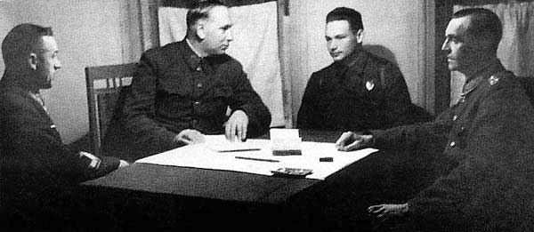 Soviet General Konstantin Rokossovsky (first from left) and Marshal of Artillery Nikolay Voronov (second from left) speaking to German Field Marshal Paulus (first from right) through interpreter Captain Nikolay Dyatlenko, Stalingrad, Russia, early Feb 1943