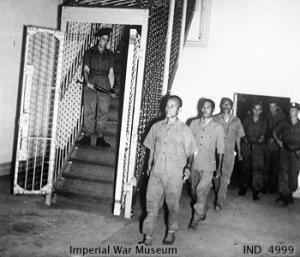 Three accused Japanese war criminal being led to their cells at the Supreme Court of Singapore, 21 Jan 1946